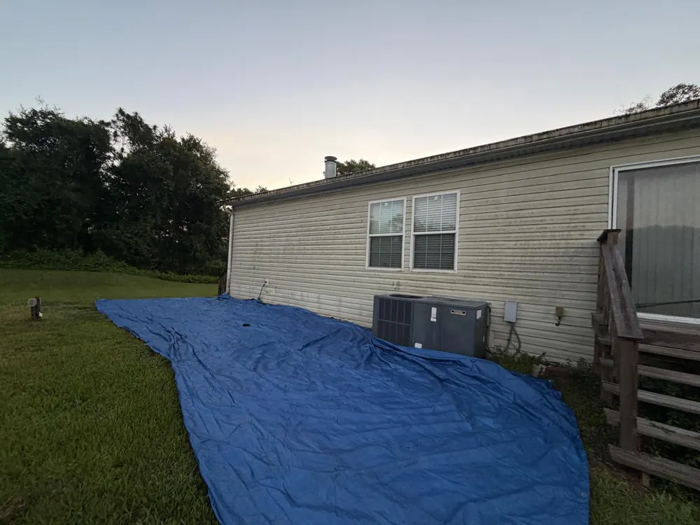 Blue tarp protecting a roof after storm damage