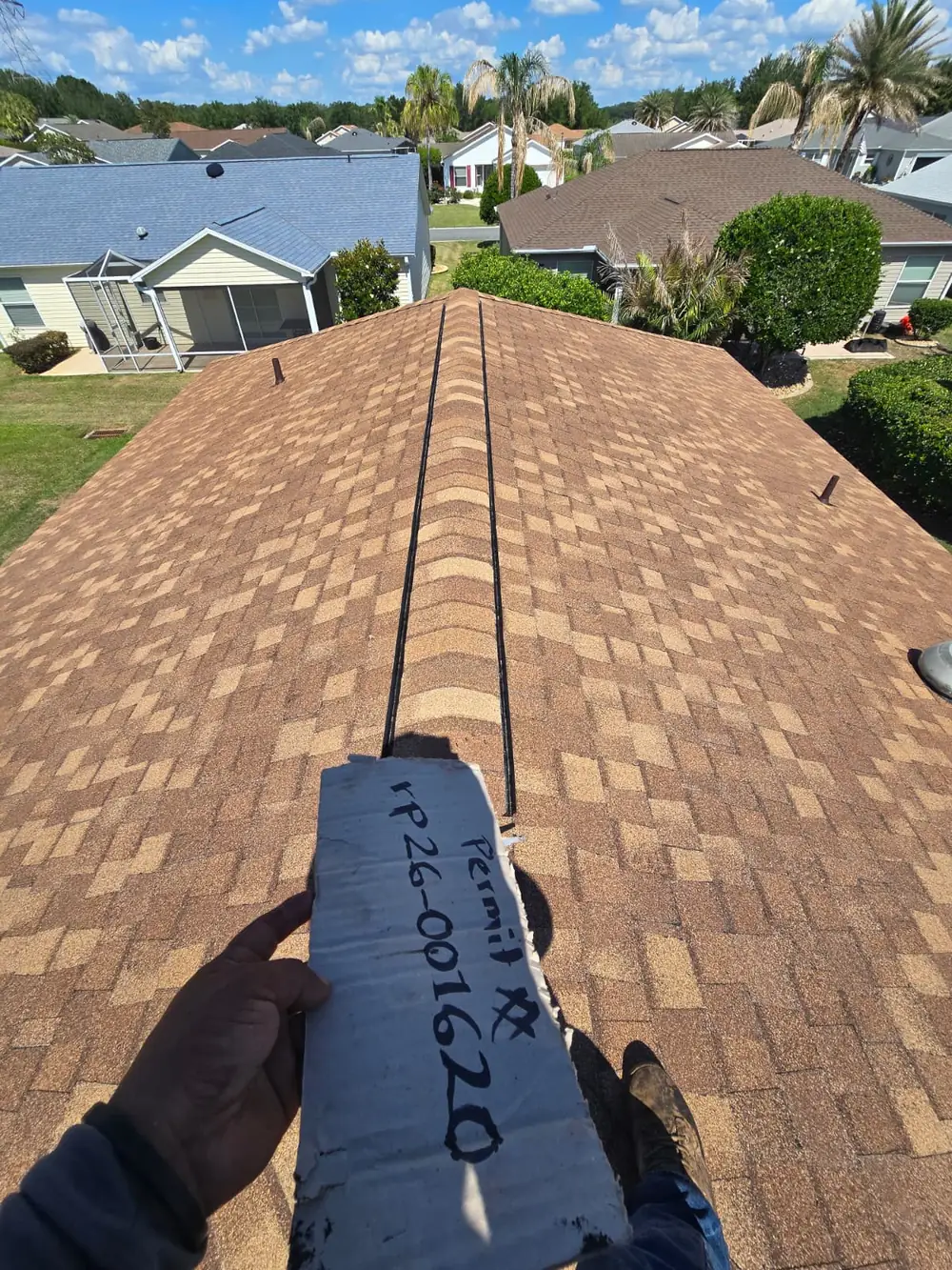 Roofer holding a shingle sample during an inspection